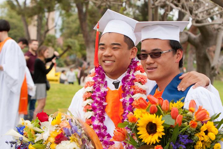 commencement 2015, two asian men with flowers